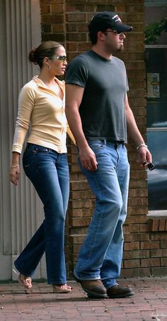 a man and woman walking down the street