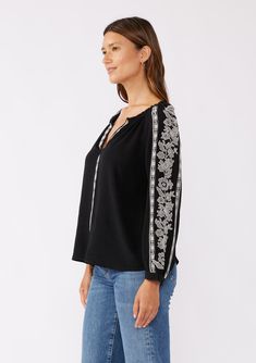 A classic boho blouse with long raglan sleeves and contrast embroidered detail throughout. Embroidered detail Relaxed fit Long raglan sleeve Single-button wrist closure Split v-neckline Bohemian blouse Dry clean recommended or hand wash cold Classically boho for any season, our effortlessly relaxed blouse is crafted from a viscose and linen blend. Featuring contrast embroidered details, long raglan sleeves, and a split v-neckline. Tuck this effortless everyday top into vintage denim and add a cl Traditional V-neck Fall Tops, Bohemian Long Sleeve Top With Embroidered Hem, Bohemian Long Sleeve Tops With Embroidered Hem, Long Sleeve Peasant Top With Embroidered Neckline For Fall, Peasant Tops With Embroidered Long Sleeves, Casual Long Sleeve Blouse With Embroidered Cuffs, Bohemian Long Sleeve Peasant Top With Embroidered Neckline, Bohemian Long Sleeve Blouse With Embroidered Hem, Casual Long Sleeve Peasant Top With Embroidered Hem