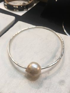 Argentium 12 gauge Sterling silver soldered with a 18-20 mm barogue pearl. Shipped with a gift card in a gift box! Specify size wrist 6,7,8 as well as a square shape Bangle. The benefit of Argentium is purity of the Sterling without the copper, will not tarnish! Pearl Bangle, 12 Gauge, Square Shape, Bangle Bracelets, Jewelry Bracelets, Gift Box, Bangles, Gift Card, Copper