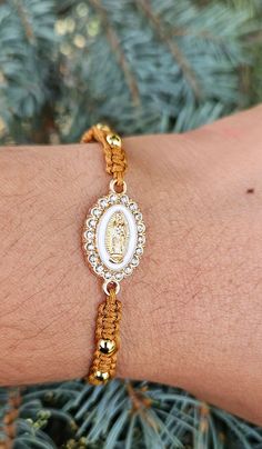 Beautiful 100% handmade thread bracelet, with a Virgin Mary charm, brown bracelet with 14k gold plated spacers adjustable bracelet for women, men, children, etc. Gold Braided Bracelets With Adjustable Length As Gift, Spiritual Gold Friendship Bracelet With Adjustable Cord, Gold Spiritual Bracelet With Adjustable Cord, Spiritual Gold Bracelet With Adjustable Cord, Gold Spiritual Friendship Bracelets As Gifts, Handmade Gold Friendship Bracelets For Gift, Gold Spiritual Friendship Bracelets, Adjustable Gold Friendship Bracelets, Spiritual Gold Beaded Bracelets With Sliding Knot