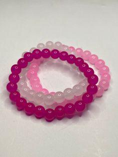 3Pc Pink beaded bracelet set. Includes hot pink, light pink and cloudy white. These bracelets have a shiny glossy look, have a cooling feel and are light weight. The color of the product may look slightly different due to lighting. Pink Stretch Bracelet With Round Beads For Friendship, Pink Hypoallergenic Beaded Bracelets, Hypoallergenic Pink Beaded Bracelets For Friendship, Pink Round Beaded Bracelets For Friendship, Pink Stretch Bracelet With Spacer Beads, Pink Hand-strung Friendship Bracelets With Round Beads, Pink Stretch Bracelet With Colorful Beads, Pink 8mm Beads Stretch Bracelet For Friendship, Pink Beaded Stretch Bracelet