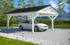 a white car is parked under a pavilion