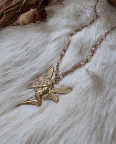 These gorgeous ethereal necklaces are made out of real rose quartz beads and brass chain. The fairy charm is vintage brass. These necklaces make a beautiful complement to any occasion and outfit 🦋 ️  Unleash your inner ethereal fairy 🌙 Necklace length I'm wearing is 19 inches Fairies and nymphs are a bit different in comparison but also very alike. Nymphs are usually human sized and extremely beautiful and ethereal beings. Fairies and pixies are tiny human like creatures who are usually little Fairy Pendant Necklace, Ethereal Handmade Gold Necklaces, Handmade Fairycore Necklaces For Festivals, Fairycore Beaded Jewelry For Festivals, Fairycore Beaded Festival Jewelry, Handmade Fairycore Festival Necklaces, Fairycore Beaded Jewelry Gift, Festival Fairycore Beaded Jewelry, Handmade Gold Crystal Necklace With Rose Quartz