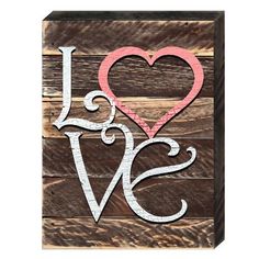 a wooden block with the word love painted on it and a heart in the middle