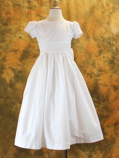 First Communion Dress Cotton Blend with Smocked Waist from Catholic Faith Store (7, White) White Cotton Dress With Pleated Bodice, Fitted Smock Wedding Dress, Fitted Wedding Dress With Smocked Cuffs, Short Sleeve Dress With Smocked Bodice For Wedding, Short Sleeve Wedding Dress With Smocked Bodice, Wedding Dress With Smocked Bodice And Short Sleeves, Fitted Dress With Smocked Bodice For Baptism, Fitted Classic Smocked Dress, Fitted White Dress With Smocked Cuffs