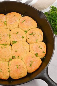 a skillet filled with lots of food sitting on top of a counter next to some parsley