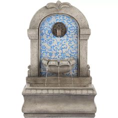 a water fountain with a blue and white tile design on the front, and a clock above it