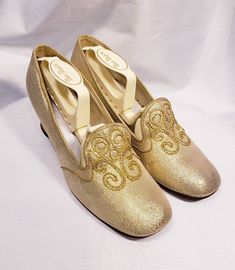 1960's gold lame' shoes with embroidered vamp and chunky heel Cute mid century modern pair of low heels. Size marked 7 B Measuresments: length ~ 9 1/2 inches, inside width ~ 2 3/4 inches, outside heel ~ 2 inches Sole reads: QualiCraft Worn 1x. These shoes are a ready to be worn! Buyer to pay all related shipping costs including insurance. Questions welcome. All Sales final Thank You CityVintage Gold Slip-on Heels For Formal Occasions, Gold Slip-on Heels For Evening, Gold Slip-on Heels For Wedding, Festive Round Toe Heels For Party, Gold Low-heel Wedding Shoes For Formal Occasions, Gold Low Heel Wedding Shoes For Formal Occasions, Gold Almond Toe Wedding Shoes, Retro Almond Toe Wedding Heels, Retro Round Toe Heels For Wedding