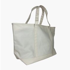 This Maxi Tote is in coated canvas and is perfect for day-to-day, beach days, groceries, and getaways. The roomy interior can carry a 17” laptop, change of clothing and other accessories. Designed with double shoulder straps, a front exterior pocket, a chunky white zipper closure, and a keyclip lanyard inside. The fabric is cotton canvas with a signature coating and is water and stain resistant and wipeable inside and out. Size: 15.5"l (base) x 14"h x 8.5"d - top width 23.5"Care: Wipe with a cle Beige Canvas Bag With Reinforced Handles For Travel, Everyday Use Large Capacity Cotton Beach Bag, Everyday Beach Bag With Leather Handles And Canvas Material, Rectangular Canvas Bag With Pockets For Weekend, Everyday Canvas Beach Bag With Leather Handles, Canvas Tote Beach Bag For Everyday Use, Casual Shoulder Bag With Canvas Lining For Weekend, Rectangular Canvas Weekender Bag With Pockets, Canvas Weekender Bag With Pockets For Daily Use