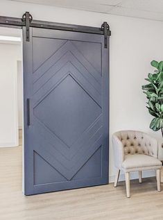 a living room with a chair and a sliding door