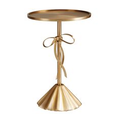 a gold table with a bow on the top and a metal plate in the middle