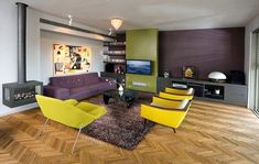 a living room filled with furniture and a flat screen tv on top of a wooden floor