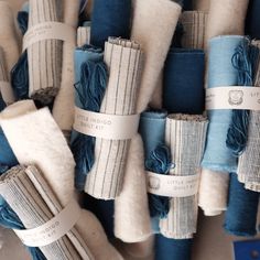 several rolls of blue and white fabric are stacked on top of each other