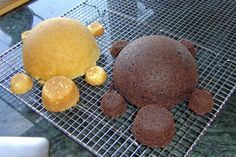 there is a chocolate cake on the cooling rack next to it's cookie pieces