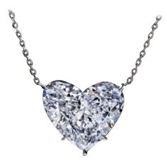 This stunning pendant necklace features a GIA-certified 4.01 carat heart-shaped diamond, set in elegant 18K white gold. The diamond boasts a E color grade, representing the highest level of colorlessness and offering a bright, pristine appearance. With a VS1 clarity grade, the diamond is nearly flawless, with only minor inclusions that are invisible to the naked eye. The excellent polish and symmetry maximize the diamond's brilliance, ensuring it sparkles beautifully from every angle. The presence of faint fluorescence ensures that the diamond's pure, clear color remains largely consistent in various lighting conditions, with only a subtle effect under certain UV light. This exquisite piece is perfect for those seeking a timeless and sophisticated expression of love and luxury. Heart Shaped Diamond Necklace, Heart Shaped Diamond Pendant, Heart Shaped Pendant Necklace, Fancy Yellow Diamond, Heart Shaped Necklace, Elegant Pendant, White Gold Necklaces, Heart Shaped Diamond, Heart Shape Pendant