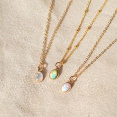 Our Dainty gemstone necklace features a tiny little stone, choose between opal, moonstone and turquoise. …………………………………. Details: Pendant is Genuine Turquoise, Genuine Moonstone, or Synthetic Opal, measuring 5 x 7mm Available in 14k Gold Filled or Sterling Silver Waterproof and can be worn everyday Average necklace length is 18" About Your Jewelry If you are not wearing your jewelry it is best to store it in a cool, dry place such as your gift box that is included in your order. Dainty Handmade Birthstone Pendant Necklace, Dainty Moonstone Birthstone Jewelry, Delicate Opal Jewelry With Birthstone, Dainty Oval Jewelry With Natural Stones, Everyday Opal Jewelry With Gemstones, Dainty Handmade Necklaces For May Birthstone, Dainty Handmade May Birthstone Necklaces, Everyday Opal Gemstone Jewelry, Delicate Opal Birthstone Jewelry