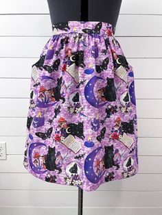 This item is MADE TO ORDER. This handmade purple skirt features black cats, mushrooms, moons, candles, flowers, and more. Perfect for fall/autumn, October, or a fun Halloween party or costume. It is made out of cotton fabric. It has a flattering flat-front waistband with elastic in the back and cutout pockets. Since the waistband stretches it fits a variety of sizes but please double check the measurement chart to ensure proper fitting. Constructed using the Cleo Pattern designed by Rae Hoekstra. Used with permission. www.made-by-rae.com Measurements: Please see the size chart in the last photo. Use the waist and hip measurements to determine your size. If you have any sizing questions or need a custom, please message me! Length: 3 lengths available. Where the skirt lands will depend on yo Handmade Skirts, Cats Purple, Halloween Skirt, Candles Flowers, Autumn October, Vinyl Bag, Cats Tote Bag, Black Witch, Fit And Flare Skirt