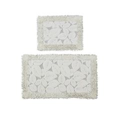 two white rugs with leaves on them