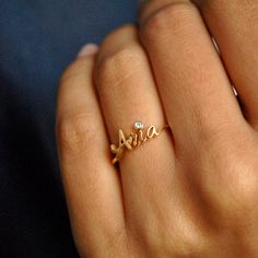 "Beautiful handcrafted 14k Solid Gold name ring. This lovely custom made ring is a perfect accessory to own or gift - for your wife, best friends, brothers, sisters and all of your loved ones :) Important dates/coordinates can also be made. We will send a drawing before starting the manufacturing process so you know what it will look like. * Diamond Color-Clarity Grade : H-I, Vs-Si * Gold - 14k Solid Gold SENDING AS A GIFT We would be happy to send your gift directly to the recipient, including Personalized Engraved 14k Gold Ring, Custom Name Yellow Gold Jewelry For Anniversary, Personalized Diamond Initial Ring For Wedding, Yellow Gold Sterling Silver Ring With Birthstone, Luxury Engraved Diamond Ring For Gift, Luxury Diamond Engraved Ring For Gift, Luxury Engraved Diamond Ring As Gift, Customizable Diamond Promise Ring, Luxury Engraved Diamond Gift Ring