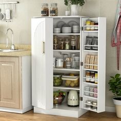 an open cabinet in the middle of a kitchen