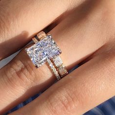 a woman's hand with a ring on it and a diamond in the middle