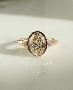 a close up of a diamond ring on a table