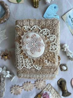 an assortment of buttons and laces on a white table cloth with other items in the background