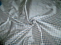 a blue and white checkered fabric on a bed