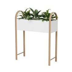 a white planter with plants in it