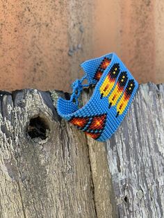 Handmade Wristband Bracelets, Handcrafted Jewelry, Beaded Woven Bracelet, Casual Appeal Multi Colored Turquoise Color Beads, 1.5 x 8 InchesSparkly seed beads where used to create this beautiful beaded bracelet.*Casual Wear Beaded Bracelet*Native American Inspired Design*The bracelet can be secured at one of three lengths with a beaded button.*Handmade in Guatemala Adjustable Blue Artisan Beaded Bracelets, Adjustable Artisan Blue Beaded Bracelets, Blue Artisan Adjustable Beaded Bracelet, Southwestern Style Large Beads Bracelet For Festivals, Blue Hand-strung Bracelets For Festival, Blue Bracelets With Colorful Beads For Festival, Unique Blue Beaded Bracelets For Festival, Artisan Blue Bracelets For The Beach, Festival Blue Bracelets With Colorful Beads