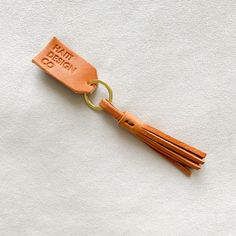 an orange leather key chain with a tag