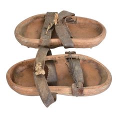 Antique Asian Primitive Wood Clog Shoes Double Leather Strap Open Toe Sandals with Cleats 19th Century Japan Pair of  Antique Wood  Iron & Leather Primitive Garden Sandals Shoes Clogs with Cleats -metal spikes on sole. Splendid character in Original antique unrestored unaltered Preowned condition.  Unsigned. No information on the maker.  Dimensions: 11.5 L x 5 W x 2.25 tall (each) inches Original vintage unrestored condition. Patina present. The leather is worn. Perfect decorative item. Refe Japanese Shoes, Gardening Shoes, Medieval Garb, Beautiful Character, Garden Shoes, Metal Spikes, Clog Shoes, Decorative Wood, Metal Tree