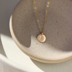 Our hand-stamped 3/8" Initial Disc Necklace adds a sweet personalized touch to your every day look. This mini monogrammed disc hangs from our favorite dainty chain. Hypoallergenic, water-proof and nickel free for long lasting everyday wear! Add a Tiny Birthstone Charm to make this necklace even more unique and gift-able. MEASUREMENTS Disc measures 3/8" in diameter Offered in 14", 16", 18", and 20"Available in 14k Gold Fill and Sterling SilverHypoallergenic, Nickel-Free, and Water Safe Minimalist 14k Gold Hand Stamped Charm Necklace, Dainty Hand Stamped Charm Necklaces For Everyday, Dainty Hand Stamped Charm Necklace For Everyday, Everyday Hypoallergenic 14k Gold Charm Necklace, Dainty Hand Stamped 14k Gold Charm Necklaces, Minimalist Hand Stamped Initial Necklace, Dainty Stamped Charm Necklaces For Everyday, Small Personalized Charm Necklaces For Everyday, Personalized Small Charm Necklaces For Everyday