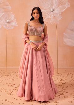 Make a stunning impression with this blouse featuring all-over 3D applique work, embellished with pearls and zari detailing. Paired with a matching skirt and dupatta, this ensemble blends intricate craftsmanship with sophisticated design, perfect for any special occasion. Pink Choli Design, Crop Top Lehenga Wedding Indian Fashion, Lehenga Crop Top Designs, Crop Top Lehenga Wedding, Pink Georgette Lehenga, Blush Pink Lehenga, Plain Lehenga, Embellished Lehenga, Bridesmaid Dresses Indian