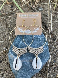 "Handcrafted micro macrame on a 2\" brass hoop with a puka shell charm. These boho beach vibe earrings will instantly transport you to vacation mode. Each shell is unique but I will careful select two that are as close to a pair as possible. Custom color cord options considered. Please DM your request." Bohemian Nickel-free Hoop Earrings For Beach, Handmade Bohemian Hoop Earrings For The Beach, Shell Dangle Hoop Earrings For Beach, Bohemian Shell Earrings For Beach Season, Handmade Dangle Hoop Earrings For Vacation, Bohemian Dangle Jewelry For Beach Season, Handmade Shell Bohemian Hoop Earrings, Handmade Shell Hoop Earrings For Beach, Bohemian Handmade Shell Hoop Earrings