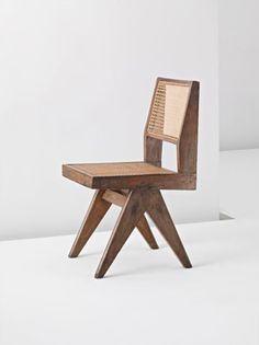 a wooden chair sitting on top of a white floor