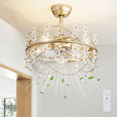 a chandelier hanging from the ceiling in a room with white walls and green leaves