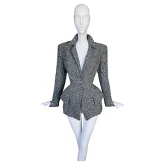 This Thierry Mugler jacket is a striking example of Thierry Mugler's excellent tailoring, combining both structure and femininity. Assuming is is from his beautiful FW 1993 Collection. The jacket is made from textured gray wool blend, and features Mugler's famous signature exaggerated silhouette. The sharp, angular shoulders emphasize power dressing, a hallmark of Thierry Mugler's work, while the dramatic cinched waist creates an hourglass figure, celebrating the female form. The exaggerated hip Mugler Jacket, Mugler Star, Black Cropped Jacket, Star Earring, Orange Jacket, Trim Jacket, Power Dressing, Lace Jacket, Thierry Mugler