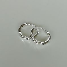 These are minimalist and twisted sterling silver hoops. Dimensions: 2 x 14 mm Weight: 1 .4 gm These earrings are made of 925 hypoallergenic sterling silver. All my pieces are sent in a gift box. I can include a personal message from you if needed. You are welcome to contact me at... bhavnakwintra1956@gmail.com More hoops: https://www.etsy.com/your/shops/TheSilverGame/tools/listings/section:26305414 More earrings: https://www.etsy.com/your/shops/TheSilverGame/tools/listings/section:26308789 Ear c Adjustable Pierced White Gold Hoop Earrings, Adjustable White Gold Hoop Earrings, Hoops Silver, Hoop Charms, Accessories Silver, Jewelry Minimalist, Silver Accessories, Sterling Silver Hoops, Jewelry Earrings Hoops