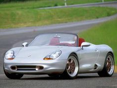 a silver sports car driving down the road