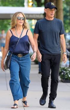 a man and woman walking down the street