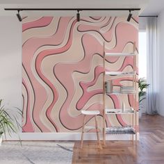 an abstract pink and beige wall mural in a living room