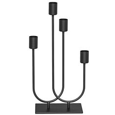 a black candle holder with three candles on it's sides and two smaller ones in the middle