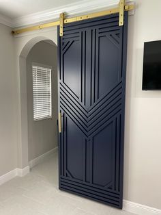 an open blue door in a room with white tile flooring and gray wall paint