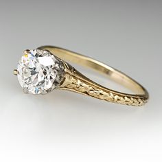 an antique diamond engagement ring with filigree details