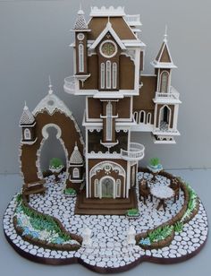 an elaborate gingerbread castle is displayed on a table