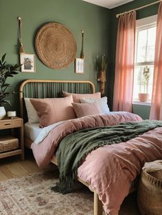 a bedroom with green walls, pink bedding and rugs on the wooden floor