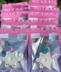 some pink bags with white snowflakes on them