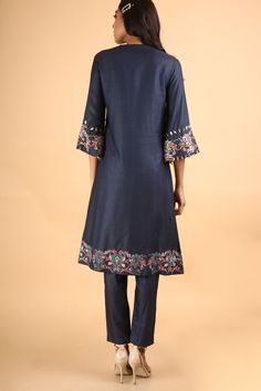 Editor's Note This set features a deep blue kurta handcrafted in silk featuring flared sleeves accentuated with hand embroidery on the sleeves and bottom. Neck: High Round Neck Sleeve Type: 3/4 Sleeve Fabric: Silk Care: Dry Clean Only Customize Your OutfitCan't find the size you're looking for? No stress. Just select the size "Custom" while adding the item to your cart. We will follow up with you for your body measurements. To request a color or design customizations, please contact our customer Eid Straight Kurta Sets With Embroidered Hem, Designer Embroidered Indigo Kurta, Unstitched Kurta With Embroidered Sleeves For Navratri, Silk Pant Set With Straight Kurta And Floral Embroidery, Silk Pant Set With Floral Embroidery And Straight Kurta, Silk Pant Set With Floral Embroidery, Traditional Blue Kurta With Embroidered Sleeves, Cotton Anarkali Sets With Embroidered Sleeves, Designer Wear Spring Kurta With Set-in Sleeves