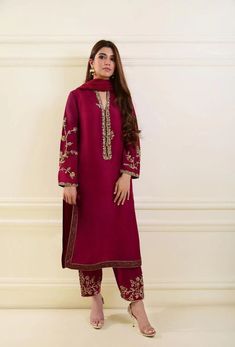 Red Silk Kurta Pant with Dupatta Set featuring heavy Zardosi work: Kurta Style: Traditional straight-cut kurta Luxurious silk fabric for an elegant look Color: Red Represents vibrancy and festivity Classic and timeless color choice Fabric: Silk Provides a smooth and lustrous texture Enhances the overall richness of the ensemble Embroidery: Zardosi Work Intricate metal embroidery using metallic threads Adds a royal and opulent touch Zari Decorative gold or silver threadwork Enhances the traditional and ethnic appeal Beads Small, decorative elements adding texture and sparkle Elevates the visual richness of the ensemble Sequins Small, shiny embellishments for a touch of glamour Creates a play of light and adds a modern flair Dupatta: Included in the set Complements the kurta and pant Can be Red And White Pakistani Outfit, Stitching Ideas For Punjabi Suits, Crushed Silk Dress, Red Suits For Women Pakistani, Punjabi Suit Designs Boutique, Wedding Pakistani Suits, Pakistani Red Suit, Red Suit Embroidery Design, Bridal Trousseau Outfits